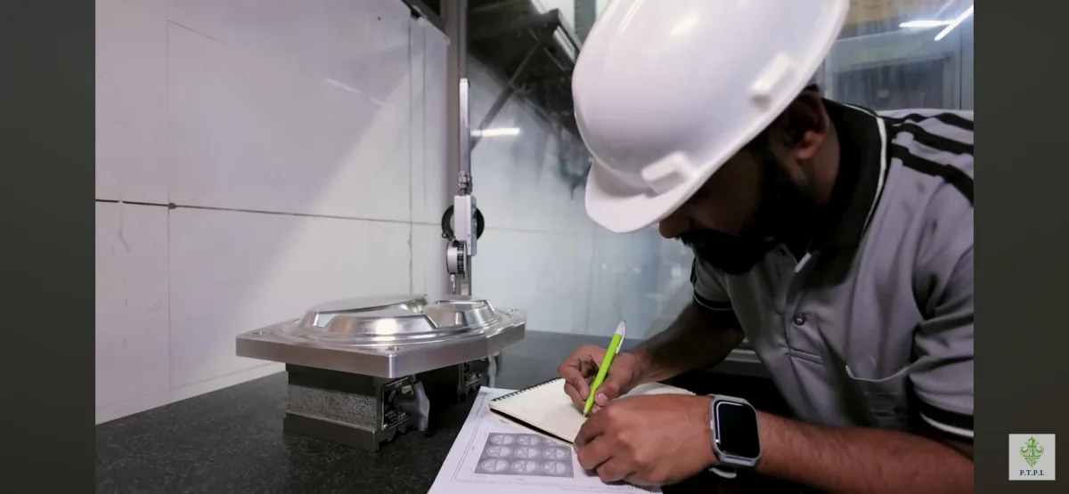 PTPL technician checking a machined component with a precision measuring instrument